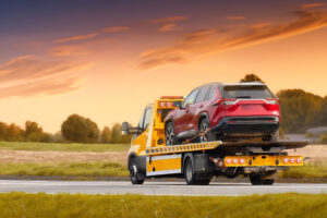 Driving through the countryside at sunset in a tow truck